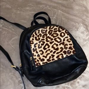 Black leather backpack with leopard patch